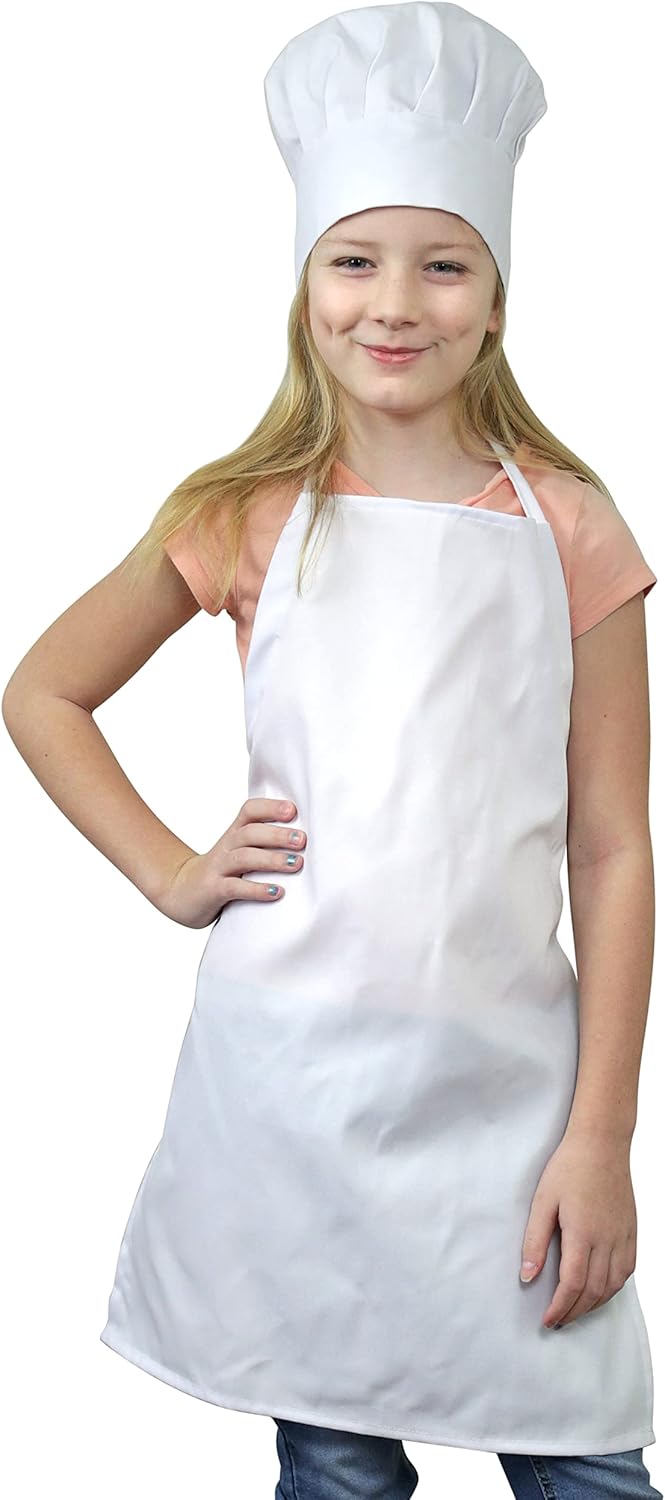 Child wearing a kids cooking apron and chef hat in the kitchen